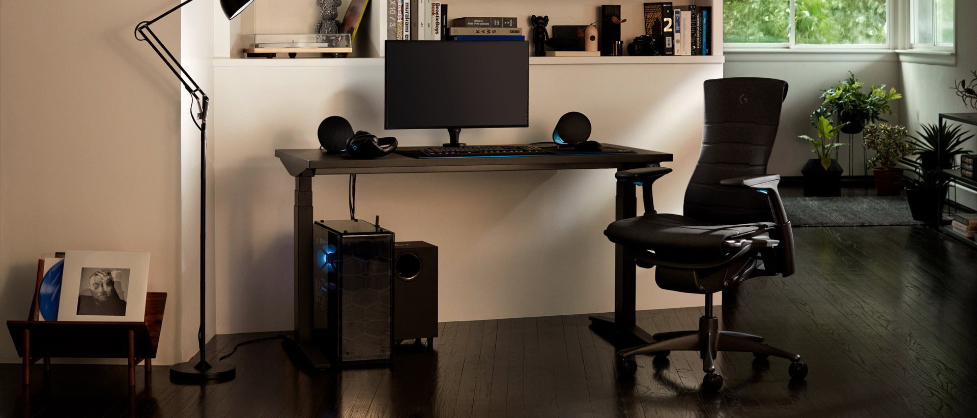 밤에 Embody Gaming Chair, Ollin Monitor Arm 및 Ratio Gaming Desk를 포함한, 전체 구성을 갖춘 주거 환경.